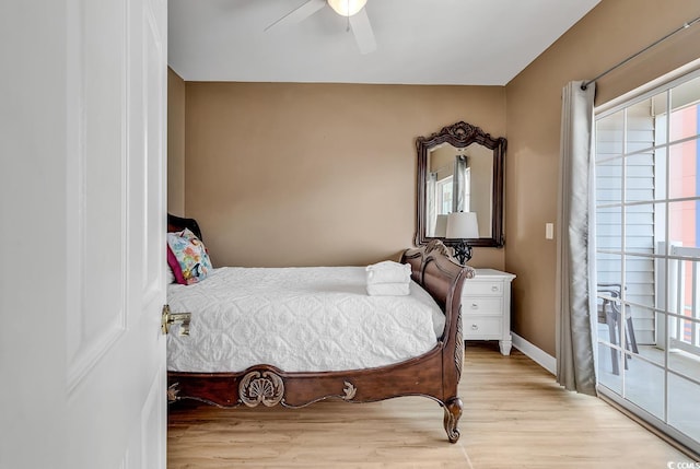 bedroom featuring light wood-type flooring, ceiling fan, and multiple windows