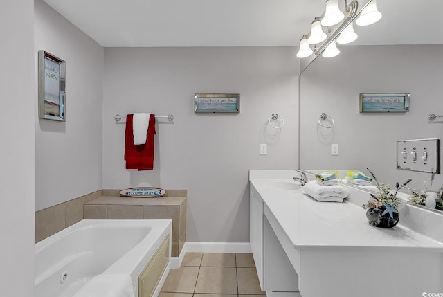 bathroom with a garden tub, tile patterned flooring, baseboards, and vanity