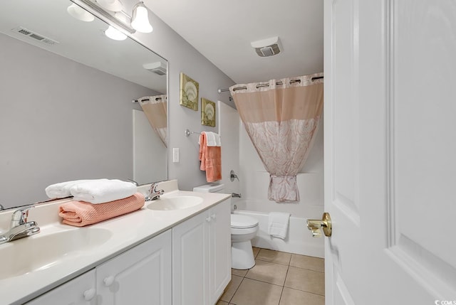 full bathroom featuring toilet, a sink, visible vents, and tile patterned floors