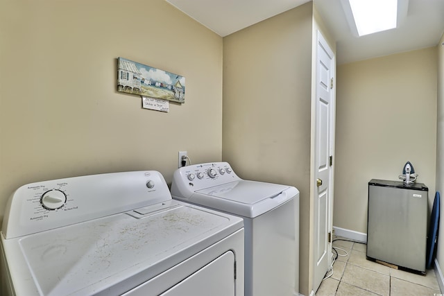 laundry area with laundry area, light tile patterned flooring, and independent washer and dryer