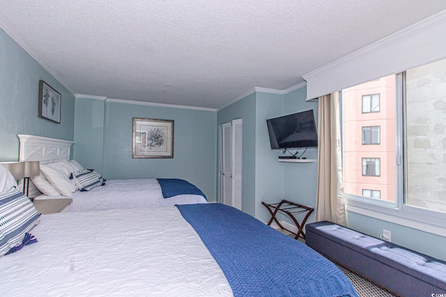 bedroom with a textured ceiling, a closet, multiple windows, and crown molding