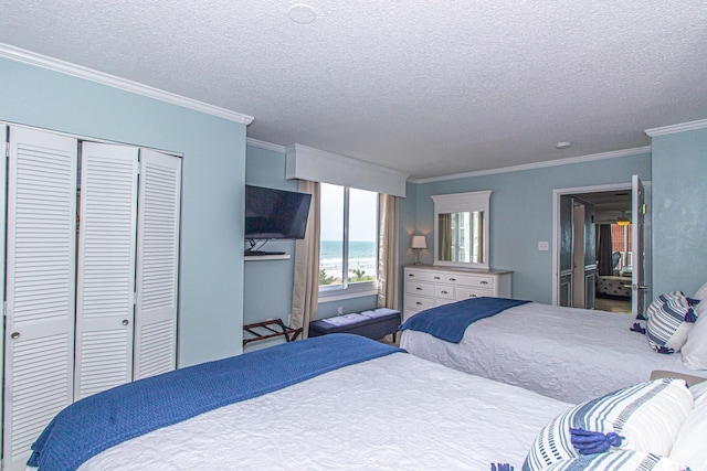 bedroom with a textured ceiling, a closet, and ornamental molding