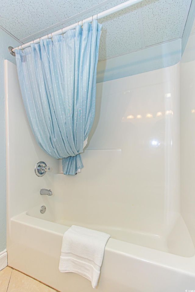 bathroom with shower / bath combination with curtain and tile patterned flooring