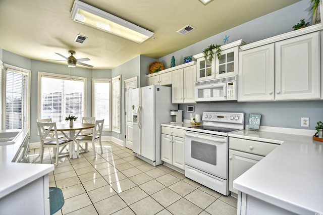 kitchen featuring light countertops, white appliances, visible vents, and light tile patterned flooring