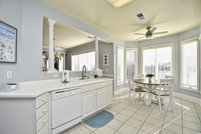 kitchen with light tile patterned floors, visible vents, dishwasher, white cabinetry, and a sink