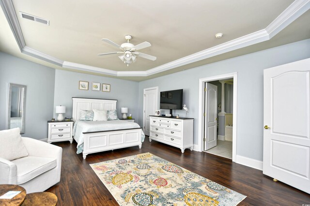 bedroom featuring hardwood / wood-style flooring, ceiling fan, ornamental molding, a raised ceiling, and ensuite bathroom