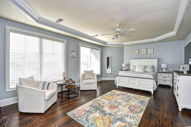 bedroom with baseboards, a tray ceiling, and dark wood-type flooring