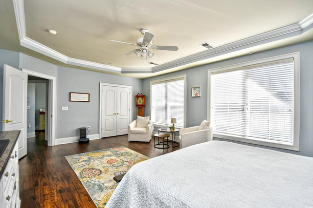 bedroom featuring dark wood-style floors, ornamental molding, visible vents, and baseboards