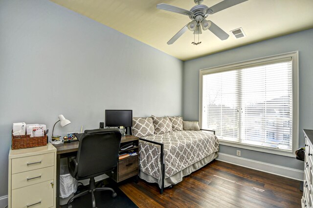 bedroom featuring dark hardwood / wood-style flooring, multiple windows, and ceiling fan