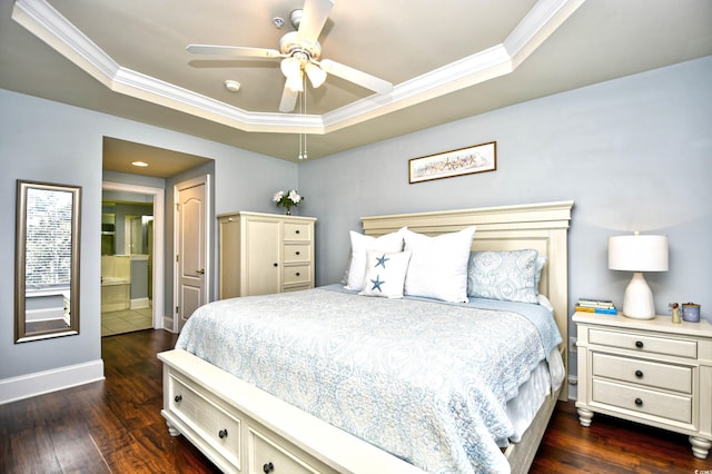 bedroom featuring a tray ceiling, dark wood-style flooring, crown molding, and baseboards