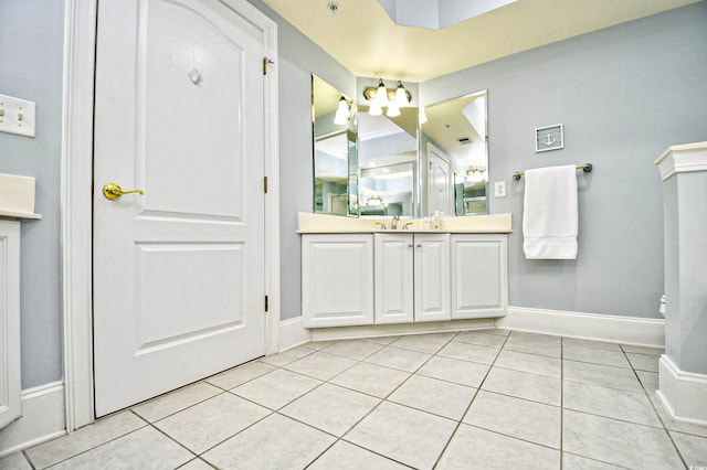 bathroom featuring baseboards, vanity, and tile patterned floors