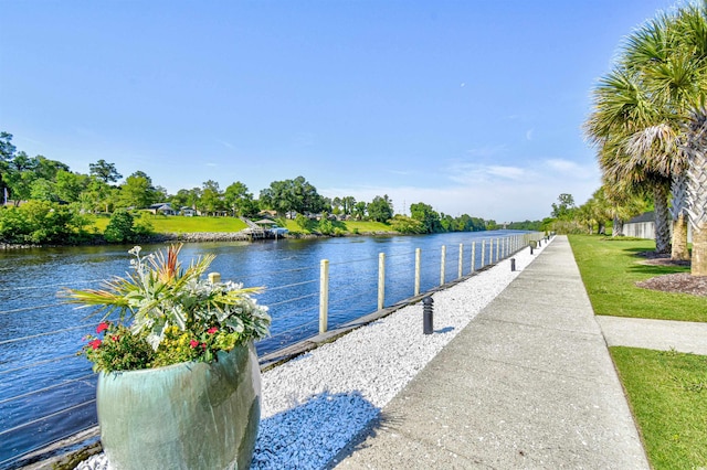 dock area featuring a water view and a yard