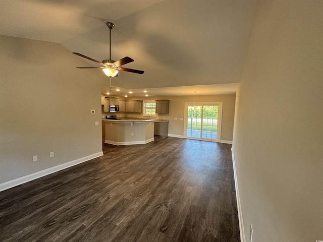 unfurnished living room featuring dark wood finished floors, baseboards, lofted ceiling, and a ceiling fan