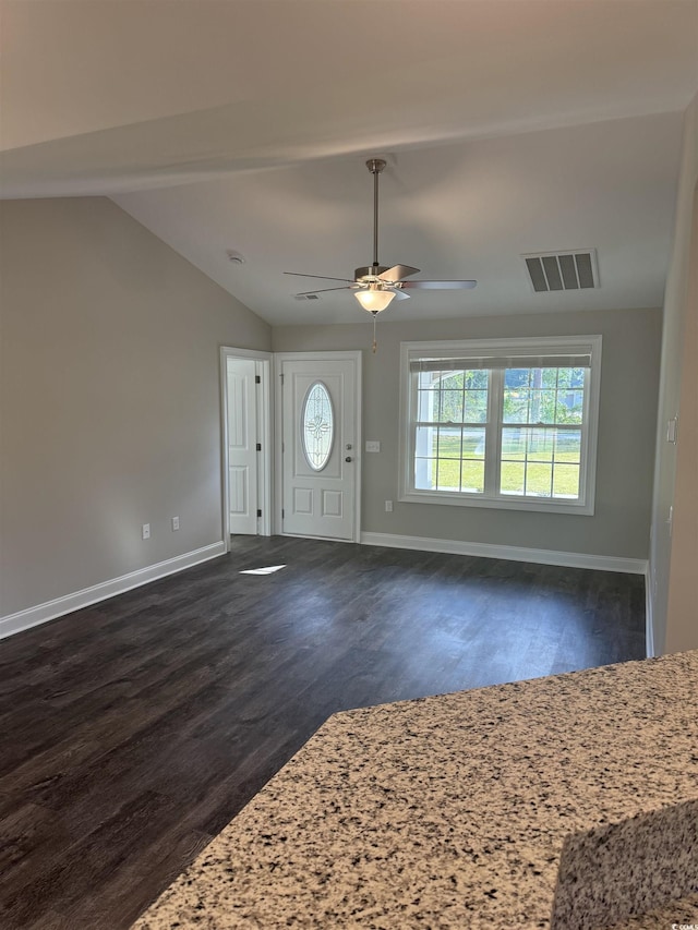 entrance foyer with visible vents, dark wood-style flooring, baseboards, and vaulted ceiling