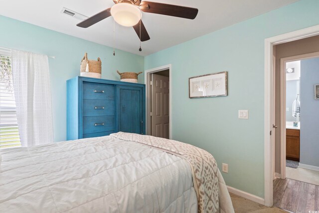 bedroom with ceiling fan and light carpet