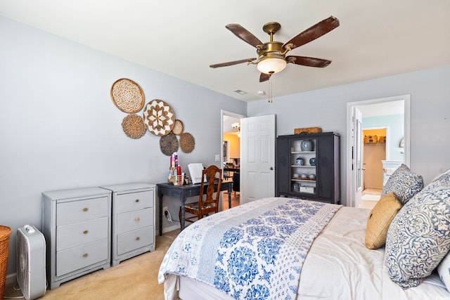 bedroom featuring ceiling fan, ensuite bath, and light carpet