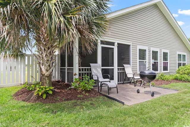 back of house featuring a patio and a lawn