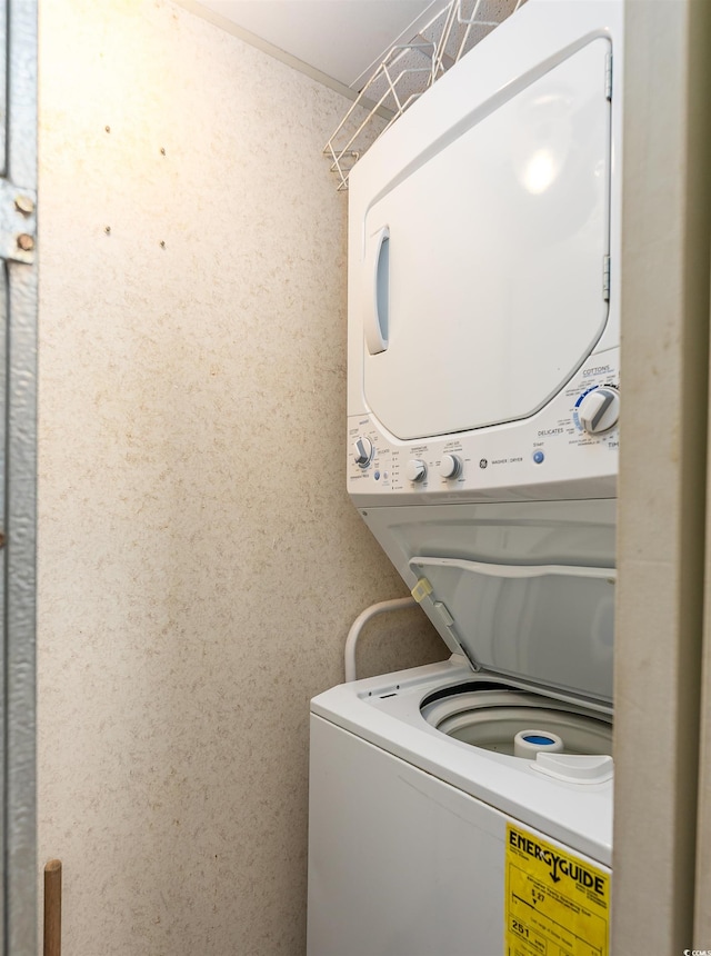 clothes washing area with stacked washer and clothes dryer