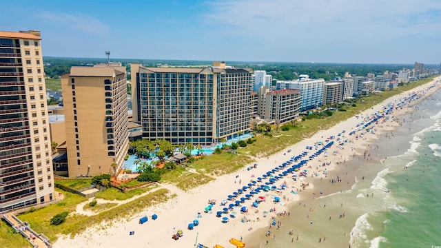 birds eye view of property featuring a beach view and a water view