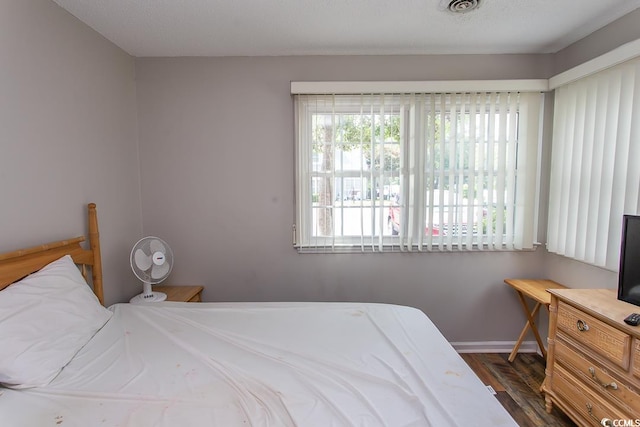 bedroom with dark wood-type flooring