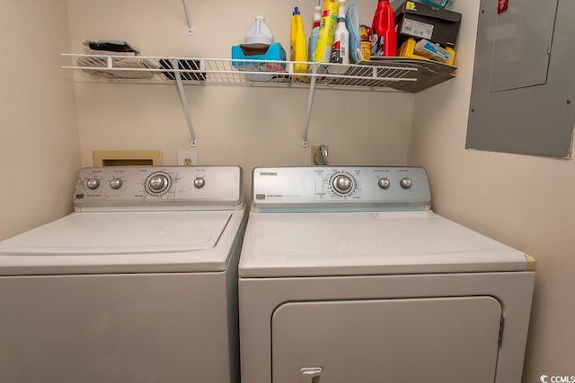 clothes washing area with independent washer and dryer and electric panel