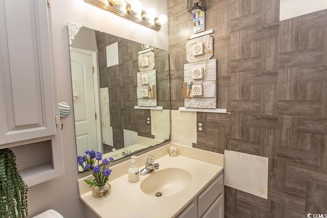 bathroom with tile walls and vanity