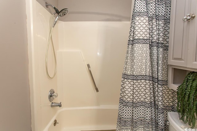 bathroom with toilet and shower / tub combo