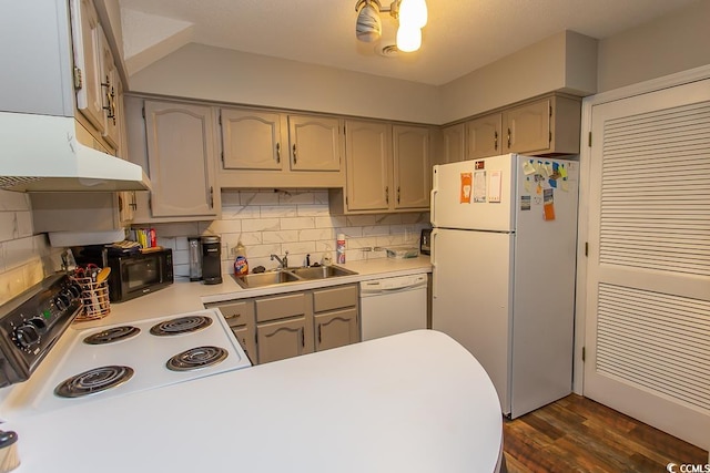 kitchen featuring sink, dark wood-type flooring, backsplash, and white appliances