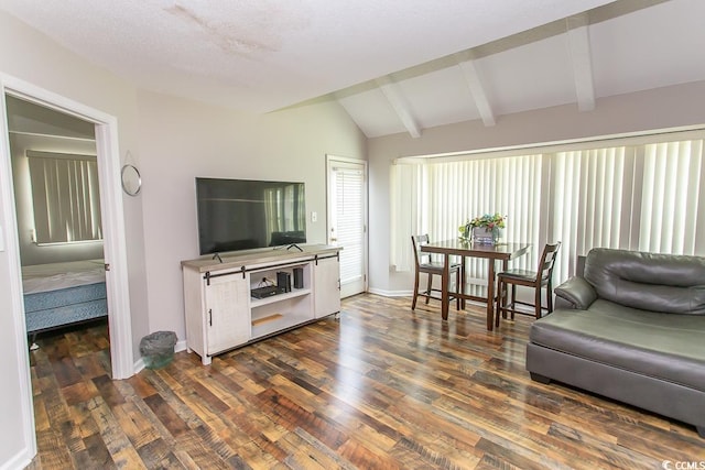 living room with dark wood-type flooring and vaulted ceiling with beams