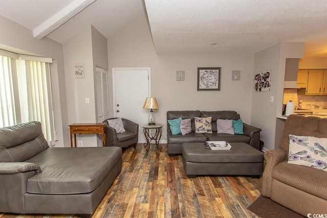 living room featuring a textured ceiling, lofted ceiling with beams, and dark hardwood / wood-style floors