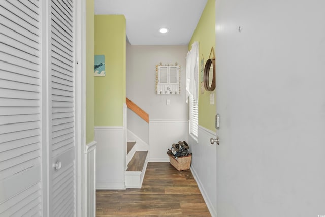 corridor featuring recessed lighting, stairs, dark wood-type flooring, and wainscoting