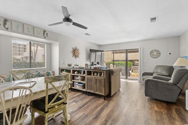 kitchen featuring dark wood-style floors, visible vents, a textured ceiling, and a ceiling fan