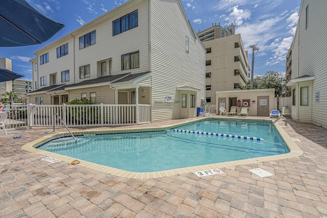 pool featuring a patio area and fence