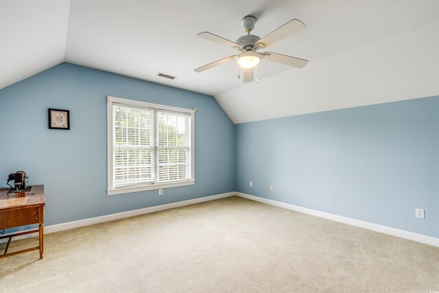 additional living space featuring light carpet, vaulted ceiling, and ceiling fan