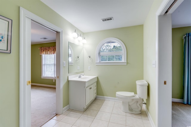 bathroom featuring tile patterned flooring, vanity, and toilet