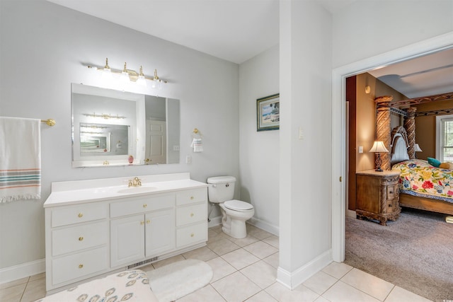 bathroom with tile patterned flooring, vanity, and toilet