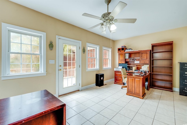 office area with a wealth of natural light, ceiling fan, and light tile patterned floors