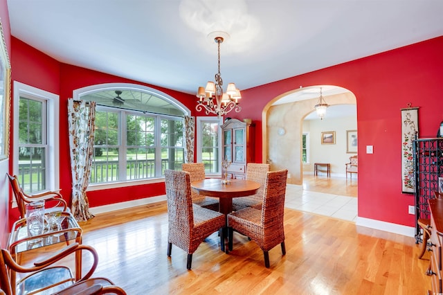 dining area with wood-type flooring and a chandelier