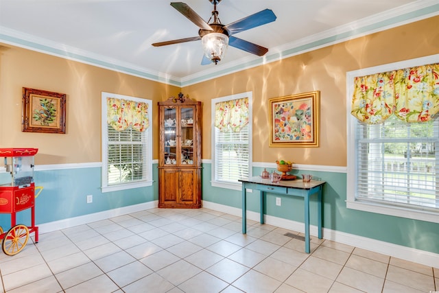 interior space with ceiling fan, crown molding, and light tile patterned floors