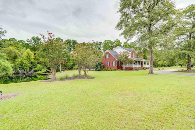 5414 Hampton Rd, Conway, SC 29527 - view of green lawn with view of scattered trees and a porch