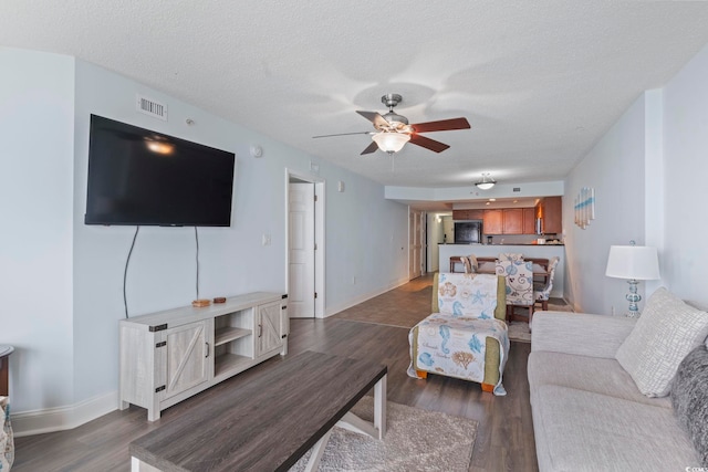 1321 S Ocean Blvd Unit 606, North Myrtle Beach, SC 29582 - living area featuring a ceiling fan, wood finished floors, and a textured ceiling