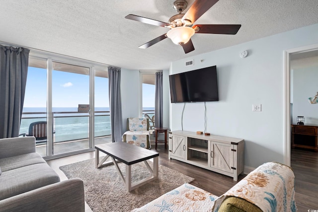 1321 S Ocean Blvd Unit 606, North Myrtle Beach, SC 29582 - living area with ceiling fan, a textured ceiling, and wood finished floors
