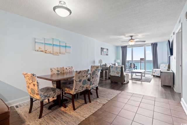 dining space with ceiling fan, a textured ceiling, and hardwood / wood-style flooring