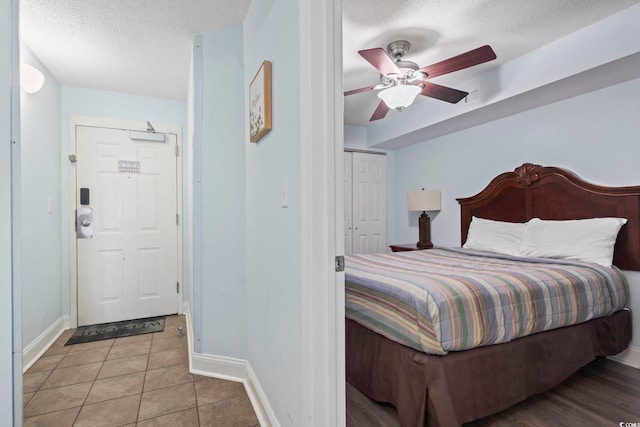 1321 S Ocean Blvd Unit 606, North Myrtle Beach, SC 29582 - bedroom with a textured ceiling, tile patterned flooring, and ceiling fan