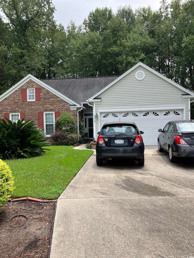 single story home with a front yard and a garage