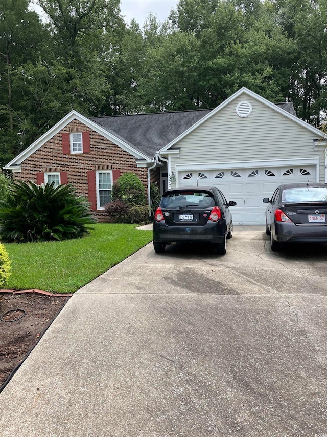 view of front facade with a garage and a front yard