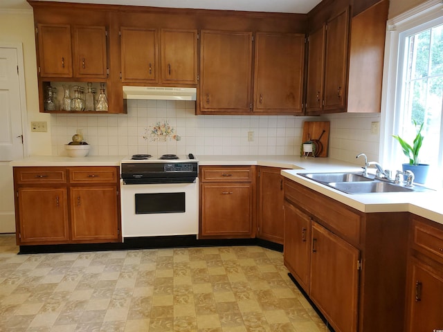 kitchen with sink, backsplash, and white range with electric stovetop
