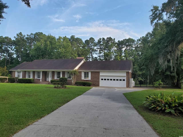 ranch-style house with a garage and a front yard