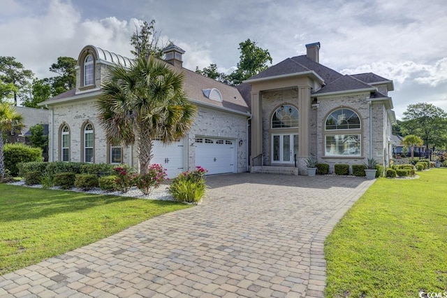 view of front of property featuring a garage and a front yard