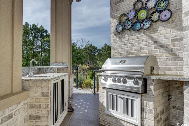 view of patio with area for grilling, exterior kitchen, and sink